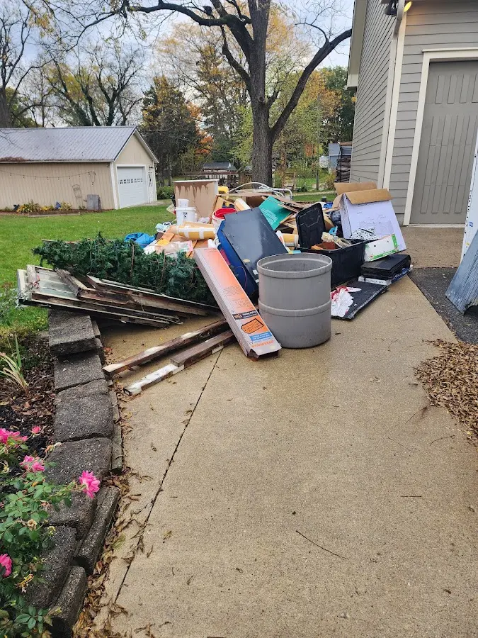 Dumpster being loaded with debris for 12 Yard Dumpster Rental in Coolidge
